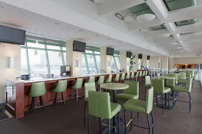 a bar with green chairs and a counter in a room at Emerald Beach #830 in Panama City Beach