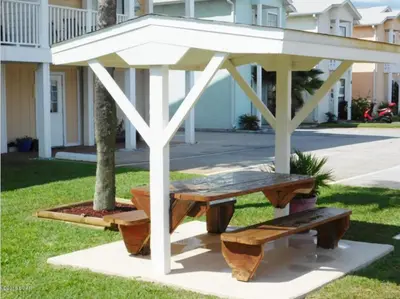 a picnic table and bench in a park at Beach Place Seconds to Beach 6 in Panama City Beach