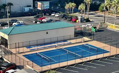 an overhead view of two tennis courts in a parking lot at Sunbird Resort! Awe-inspiring Views Throughout! hosted by Dolce Vita Getaways PCB in Panama City Beach