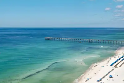 an aerial view of a beach with a pier at Aqua Resort 906 by Emerald Coast Retreats in Panama City Beach