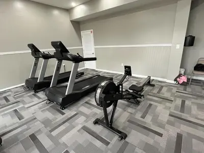 a gym with two treadmills and two exercise bikes at Horizon South 83d in Panama City Beach