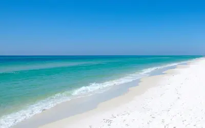 a beach with white sand and blue water at The Pointe 1-134 in Inlet Beach