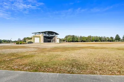 an empty field with a building in the background at Boardwalk Beach Resort #1400 by Book That Condo in Panama City Beach