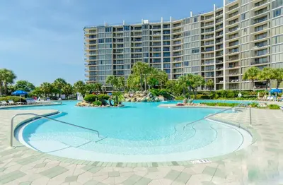 a large swimming pool in front of a large building at Edgewater Villa 3001 'Vitamin Sea' in Panama City Beach