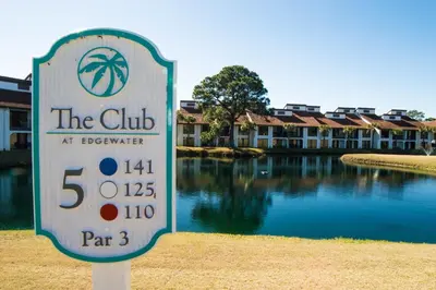 a sign in front of a building with a pool of water at Edgewater 3-0404 'Isle Be Back' in Panama City Beach