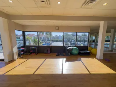 a large room with a gym with large windows at Edgewater Villa 2708 'Lost Shaker of Salt' in Panama City Beach