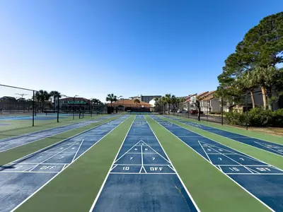 a tennis court with green and blue at Edgewater 2-0409 'Paradise City' in Panama City Beach