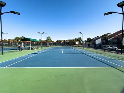 a tennis court with two people on it at Edgewater Villa 0402 'Serenity Now' in Panama City Beach