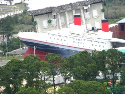 a large cruise ship parked next to a building at Top Of The Gulf 316 'Coastal View' in Panama City Beach