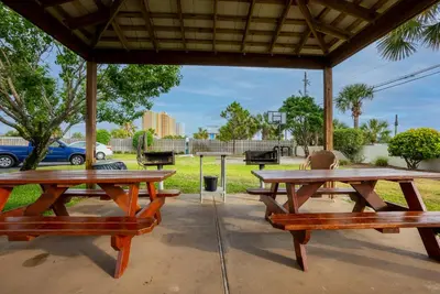 two picnic tables under a pavilion in a park at Commodore 1309 'Paradise Pass' in Panama City Beach