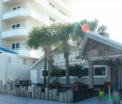 a restaurant with palm trees in front of a building at Dunes of Panama E1703 'After-Dune Delight' in Panama City Beach