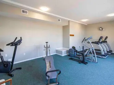 a gym with treadmills and exercise equipment in a room at Horizon South #57-203 in Panama City Beach