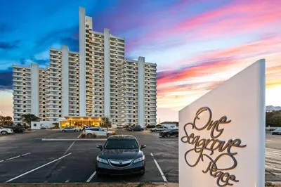 a car parked in a parking lot in front of a large building at One Seagrove Place 0605 in Santa Rosa Beach