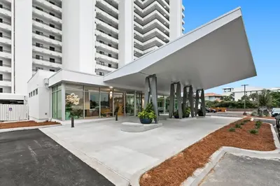 a large white building with a large white facade at One Seagrove Place 1101 in Santa Rosa Beach