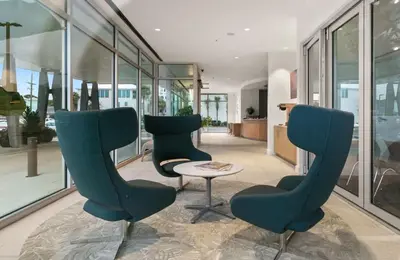 two chairs and a table in a room with windows at One Seagrove Place 1302 in Santa Rosa Beach