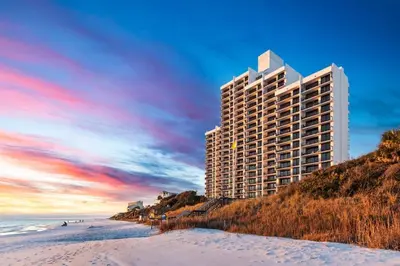 a tall building on the beach next to the ocean at One Seagrove Place 1306 in Santa Rosa Beach