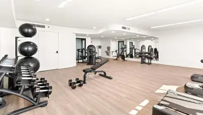 a gym with several treadmills and exercise bikes at One Seagrove Place 1407 in Santa Rosa Beach