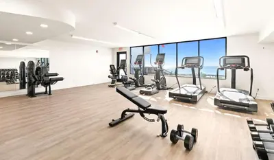 a gym with several treadmills and exercise bikes at One Seagrove Place 1407 in Santa Rosa Beach