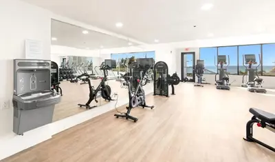 a gym with treadmills and exercise bikes in a room at One Seagrove Place 1407 in Santa Rosa Beach