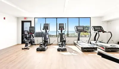 a gym with a row of exercise bikes in a room at One Seagrove Place 1407 in Santa Rosa Beach