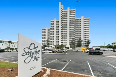 a parking lot with a large building in the background at One Seagrove Place 1206 in Santa Rosa Beach