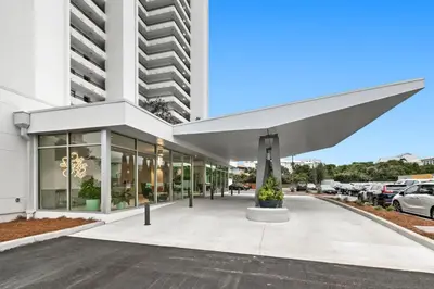 a large white building with a large awning at One Seagrove Place 1206 in Santa Rosa Beach