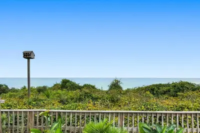 a wooden fence with a light pole in the background at One Seagrove Place 1206 in Santa Rosa Beach