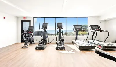 a gym with a row of cardio machines at One Seagrove Place 0402 in Santa Rosa Beach