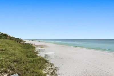 a beach with a row of white buckets on it at One Seagrove Place 1603 in Santa Rosa Beach