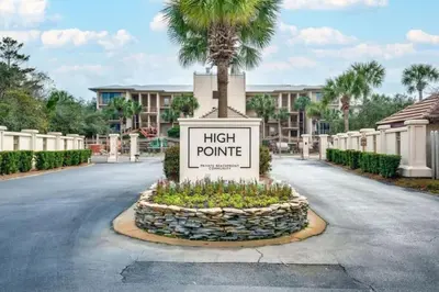 a sign with a palm tree in the middle of a road at High Pointe Resort 432 in Inlet Beach