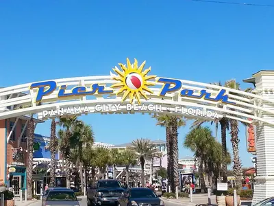 a sign for a park with cars parked on a street at Ocean Villa 2004 by Emerald Coast Retreats Unit in Panama City Beach