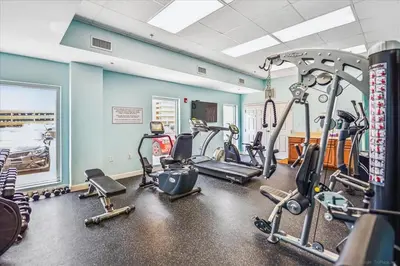 a gym with several treadmills and exercise bikes at 1409-Seychelles in Panama City Beach