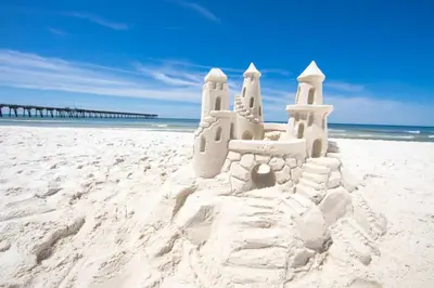 a sand castle on a beach next to the ocean at Southwinds Unit D3 in Panama City Beach