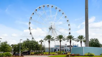 a ferris wheel in a park with palm trees at Villas Bahama West 106 in Panama City Beach