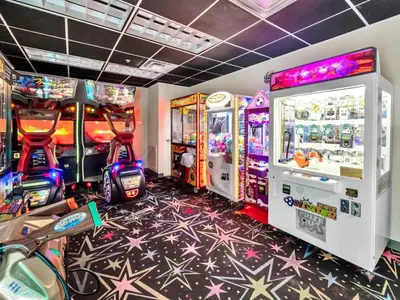 a gaming room with arcade games and consoles at Tidewater 1802 in Panama City Beach