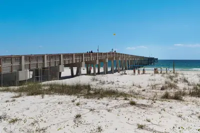 a pier on a beach next to the ocean at Watercrest 1502 - Walkin’ on Sunshine in Panama City Beach