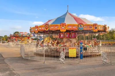 a carnival with a carousel in a park at Watercrest 1502 - Walkin’ on Sunshine in Panama City Beach