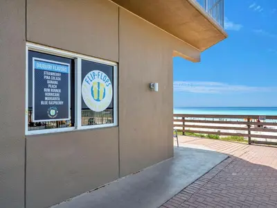 a building with a window with a view of the beach at Tidewater 2604 - SunBeam Dreams in Panama City Beach