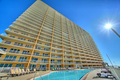 a large building with a pool in front of it at Treasure Island 1806 in Panama City Beach