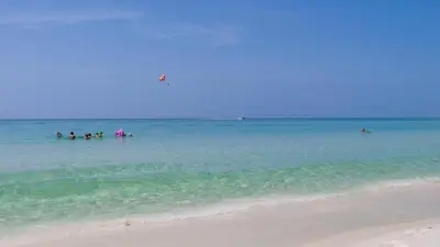 a group of people in the water at the beach at Eastern Shores 215 in Santa Rosa Beach