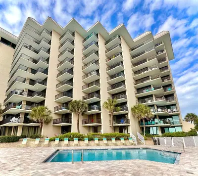 a large apartment building with a pool in front of it at Pelican Walk 204 in Panama City Beach