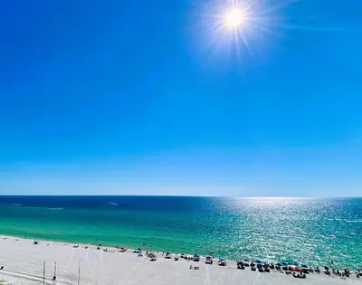 a view of a beach with the sun over the ocean at Pelican Walk 604 in Panama City Beach