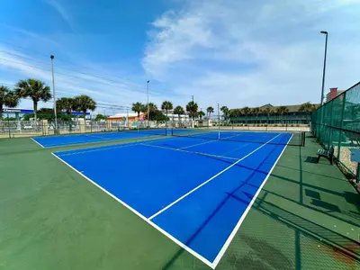 a tennis court with a blue tennis court at Pelican Walk 902 in Panama City Beach