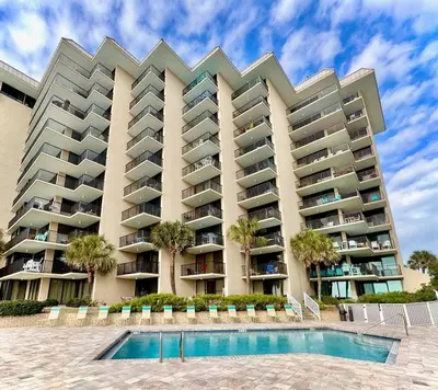 a large apartment building with a swimming pool at Pelican Walk 706 in Panama City Beach