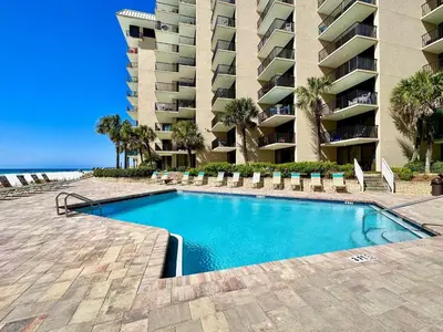 a swimming pool in front of a large apartment building at Pelican Walk 1006/1007 in Panama City Beach