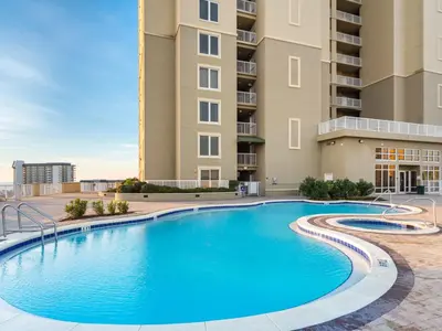 a swimming pool in front of a building at Grand Panama Beach Resort - The Grand II #803 in Panama City Beach