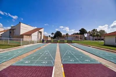 an empty tennis court in front of a building at Renovated Townhome 5 mins walk to Beach, in the best resort in PCB, Horizon South in Panama City Beach