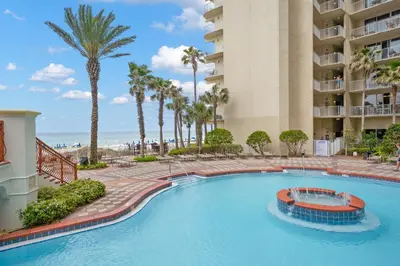 a swimming pool at a resort with palm trees at Shores of Panama Chic 2-BD Beachfront Resort Condo! by Dolce Vita Getaways! in Panama City Beach