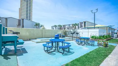 a group of blue tables and chairs on a patio at -BeachFront Premium-Summit 1124 in Panama City Beach