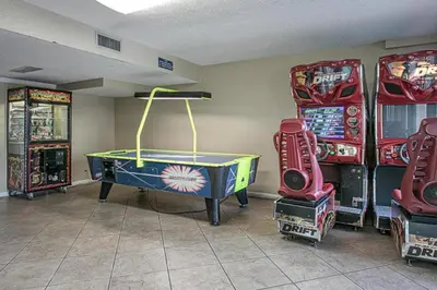 a room with arcade games and a ping pong table at -BeachFront Premium-Summit 1124 in Panama City Beach